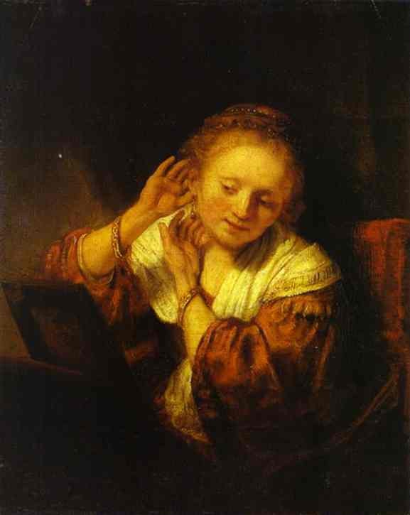 Woman Trying on Earrings - Rembrandt van Rijn